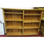 A stripped pine two divisional floorstanding open bookcase with adjustable shelves 161cm w x27cm d x