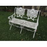 A good quality heavy gauge painted cast alloy two seat garden bench with decorative pierced and