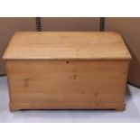 A 19th century stripped and waxed pine blanket box with hinged lid, exposed dovetail construction