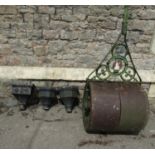An antique cast iron garden roller, with oval seated Britannia plaque, 58cm (full width) together
