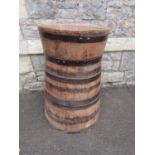 A large coopered oak and steel banded barrel/tub of tapered and flared form, approx 60cm diameter