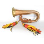 A copper and brass Military bugle with Royal Artillery tassel. (Lacks mouth piece).