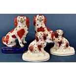 A pair of 19th century Staffordshire spaniels with rust red panels and a further pair of spaniels