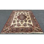 A Persian design Wilton type machine made carpet with an all over floral pattern on a cream ground