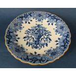 18th century blue and white tin glazed plate with floral detail and picket fence in a chinoiserie