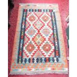 A Chobi Kilim, with a central panel interspersed with interlocking stepped medallions 155 x 101cm