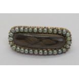 19th century yellow metal mourning brooch containing plaited hair within seed pearl surround, 3.3g