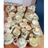 An extensive collection of Crown Staffordshire Hollyhock pattern teaware including tea cups,