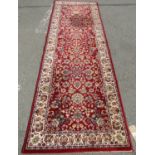 A Small Persian Sultanabad Style Runner with floral sprays on a red ground, 250 x 82 cm