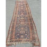 An old Persian hand knotted runner with an all over stylised floral design, 346 cm x 104 cm