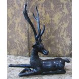 A pair of bronze stags in recumbent pose, 90 cm length x 80 cm high