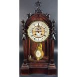 A Victorian mantle clock, the case with gothic tracery outline including pinnacles, enclosing an