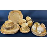 A Crown Staffordshire lemon ground tea set with printed floral detail