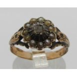 19th century yellow metal cluster ring set with a square diamond within seed pearl surround, size R,