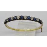 Fine early 20th century old cut sapphire and diamond hinged bangle, set with nine sapphires and