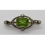 Belle Epoque peridot and diamond brooch in yellow metal with white metal setting, 3.1cm W approx,
