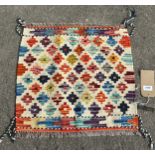 A Chobi Kilim cat mat with a small repeating pattern of stepped diamonds, 48 x 51cm approx.