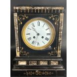 A Victorian black slate and polished marble mantle clock with further gilded highlights, enclosing a