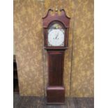 A Regency mahogany longcase clock with string banded inlay, the arched hood enclosing a painted
