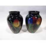 A pair of Royal Stanley Ware Jacobean pattern oviform vases with repeating tulip detail upon a