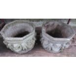 A pair of weathered cast composition stone garden planters of octagonal form, with repeating