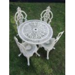 A painted and weathered cast aluminium garden terrace table with decorative pierced circular top,
