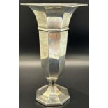 An octagonal silver posy vase, 17 cm high, a single silver candlestick and an Eastern silver metal