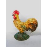 A polychrome painted cast iron Arles Cockerel doorstop 21cm tall.