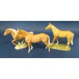 A Beswick figure of a cantering palomino horse number 1370 together with from The Royal Doulton
