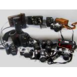 Four NE Super Pentax cameras, a Vivitar flash, an Olympus SP-570UZ camera, a Fuji film 71530 and