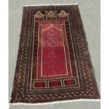 A Balouchi prayer rug, in brown, purple and varying red tones, approx. 130 x 82 cm