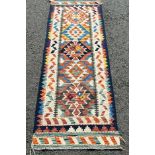 A Chobi Kilim runner with a central panel of alternating stepped and diamond medallions 201 x 70cm