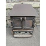 A cast iron wood/log burning stove, 62cm high x 60cm wide x 50cm deep