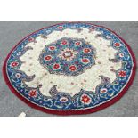 A circular hand knotted carpet of Middle Eastern design of a central floral medallion with a