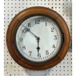 A small dial clock in a moulded oak frame with eight day time piece