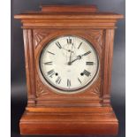 A 19th century American mantle clock by Seth Thomas, the circular dial set within an American oak