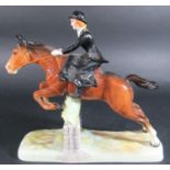 A Beswick figure of a huntswoman riding side saddle clearing a fence