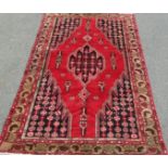 A North-west Persian Tafresh Rug, with a central diamond medallion on a crimson field, 190 x 125 cm