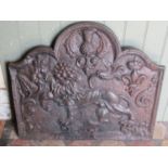 An old English cast iron fire back of traditional form with lion, thistle, rose and other detail,