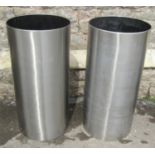 A pair of contemporary stainless steel cylindrical vessels, 35cm diameter x 81cm high