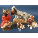 A Staffordshire pottery figure of a fox in recumbent pose dressed in a red hunting jacket,