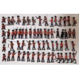 A large collection of Britains hollow cast military guardsmen in marching and firing positions, with