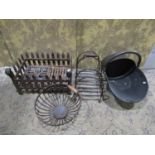 An iron fire grate of traditional form, 47cm long, a 19th century copper coal helmet, a wire