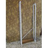 Mid 20th century ladderax type shelving comprising two painted metal uprights, six teak shelves ,and