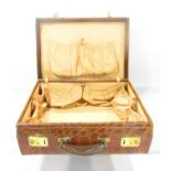 A vintage crocodile suitcase in cigar tones, decent stitching throughout, with sturdy handle and