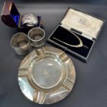 A selection of silver including an ashtray, three napkin rings, a spur shaped sprung tong, 6 oz