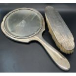 A early 20th century silver hand mirror and matching clothes brush, (as found).