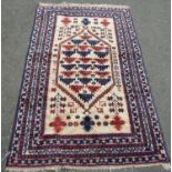 A Middle-Eastern rug hand-knotted with central design surrounded by three borders, in natural