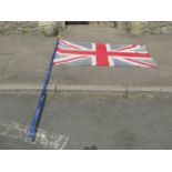 A union jack flag and painted wooden pole with pointed finial (9.5 feet approximately)