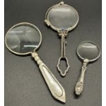 A collection of silver stylish looking glasses, including a pair of lorgnettes with decorative